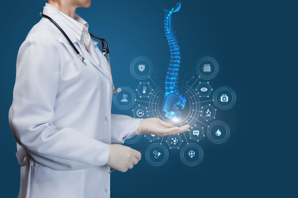 Doctor showing spine on blue background.
