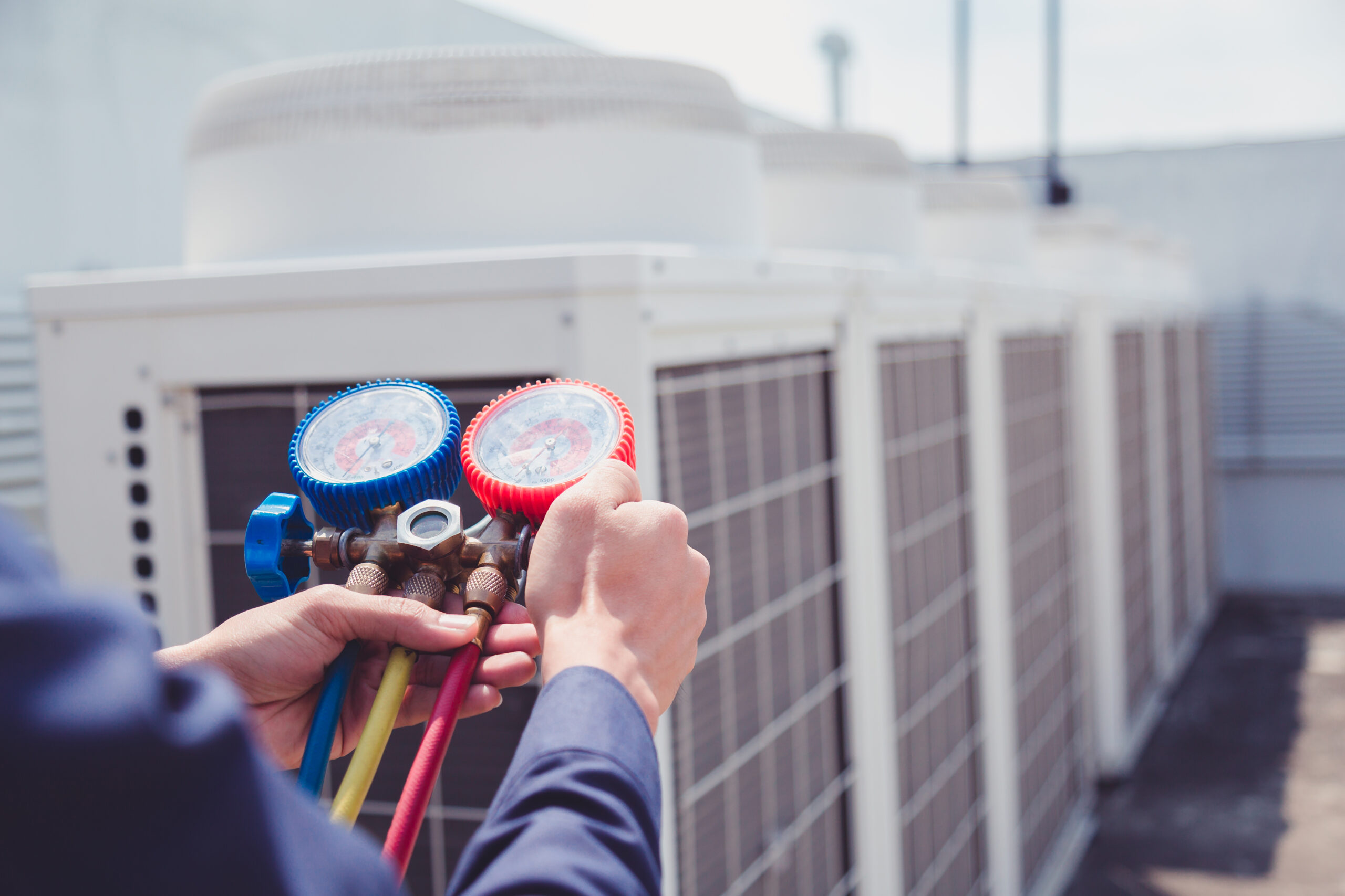 Technician is checking air conditioner ,measuring equipment for filling air conditioners. Technician is checking air conditioner ,measuring equipment for filling air conditioners.