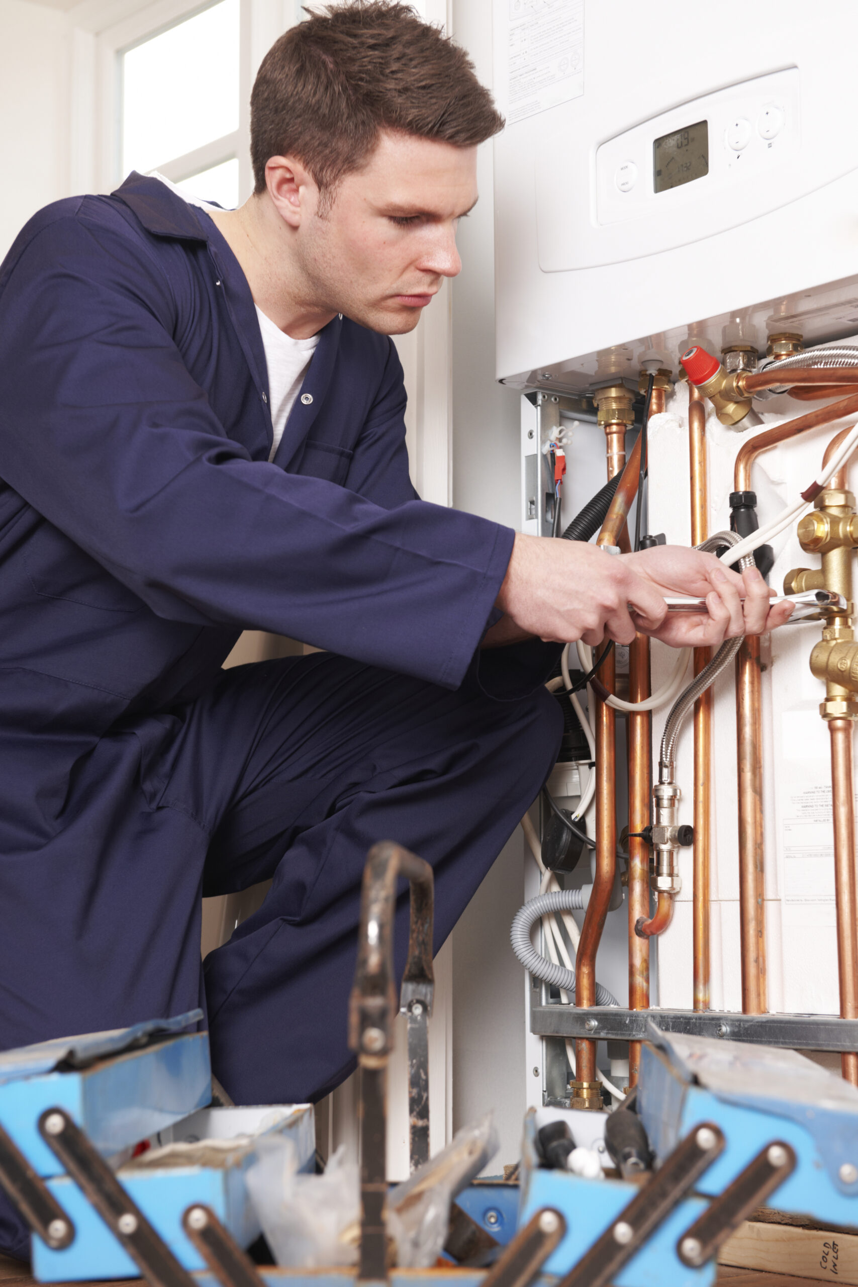 Engineer Servicing Central Heating Boiler Skilled tradesman running own business